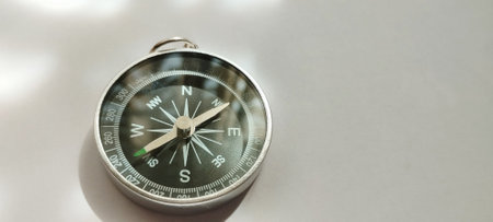Exploring navigation techniques with a vintage compass outdoor adventure photography natural lighting close-up view travel insightsの写真素材
