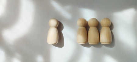 Gathering of wooden figures minimalist studio conceptual art soft lighting top-down view unity and diversityの写真素材
