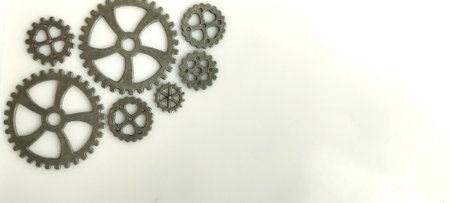 Mechanical gears and cogs arrangement industrial workshop close-up image neutral background creative engineering conceptの写真素材