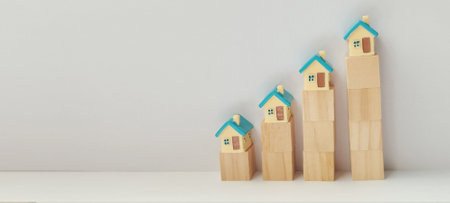 Real estate growth wooden house models showing market trends minimalist setting infographic view business conceptの写真素材