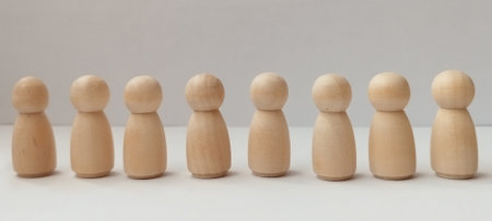 Wooden figurines arrangement studio setting minimalist art neutral background close-up perspective art conceptの写真素材
