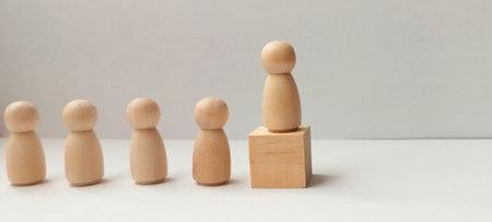 Leadership in action wooden figures representing team dynamics minimalist setting conceptual perspectiveの写真素材