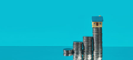 Investing in real estate home on coin stack business growth concept modern environment close-up viewの写真素材