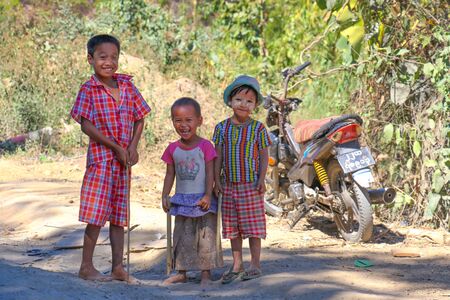 Tharrawaddy, Myanmar - February 4, 2019: Burmese poor kids smiling to the cameraのeditorial素材