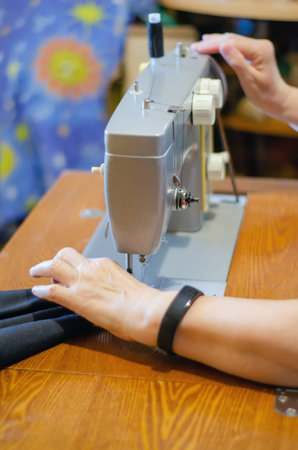 working with a black cloth on a Soviet sewing machine with black threads