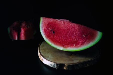 sliced juicy ripe watermelon on a dark background for the menu