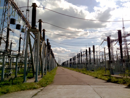 high-voltage electrical towers on a background of blue sky with clouds