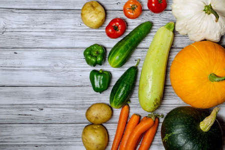 Fresh colorful organic vegetables from above. Top view, flat lay. Different vegetables for eating healthy on dark background. Clean eating food frame. Copy space. Vegetarian, vegan.の写真素材