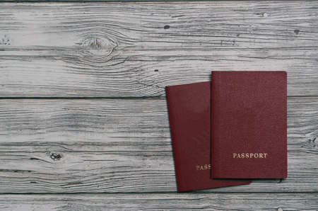 Two passports with on a wooden background for customs top view. place for textの写真素材