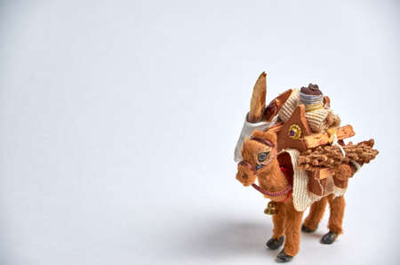 Toy camel with a load on the humps close-up on a light background.の写真素材