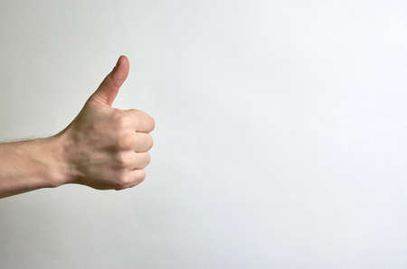 Thumb male right hand on a white background with place for text. Like, approval, classy, compliment male left hand on a white background with place for text. How, approval, cool, complimentの写真素材
