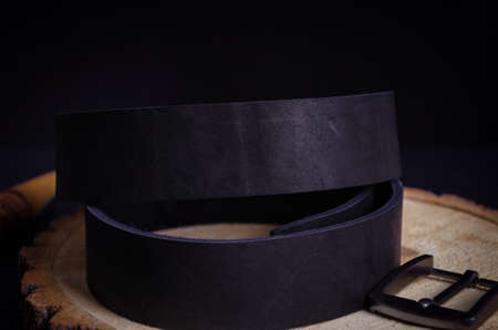 Black blank for men's leather belt on a dark background with a metal buckle.Macroの写真素材
