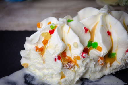 Ice cream ice cream sprinkled with colored pieces of fruit, quench thirst, cool. close upの写真素材