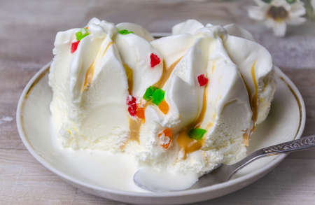 Close-up ice cream sundae with colored fruit slices on a white plate.Thirst,の写真素材