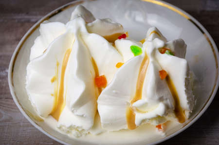 Close-up ice cream sundae with colored fruit slices on a white plate.Thirst,の写真素材