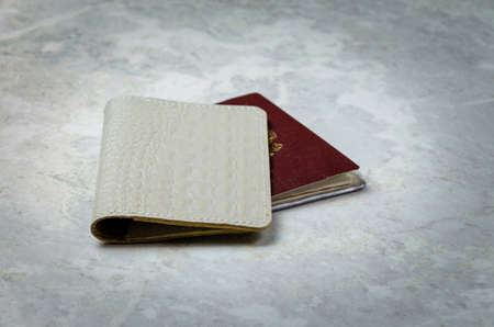 White genuine leather cover, caiman, handmade for identity document on light background, close-upの写真素材