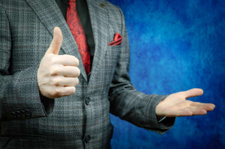 Man showing thumbs up in suit.の写真素材
