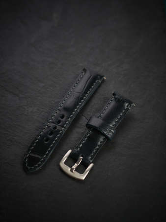 Black leather mens watch band, handmade on black stone.の写真素材