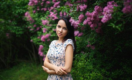 Beautiful young girl portrait in a pink flowersの写真素材