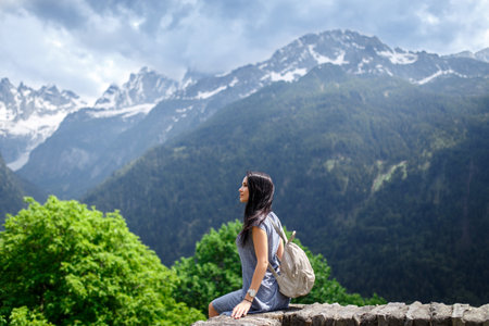 Beautiful young tourist girl with backpack in natureの写真素材