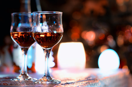 Two glass glasses with drink standing on a table.の写真素材