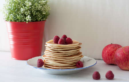 Pancake stack with blackberries on a background of a flowerの写真素材