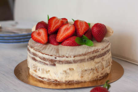Sponge cake decorated with strawberriesの写真素材
