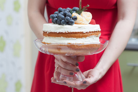 Biscuit cake with fruit hat on a white backgroundの写真素材