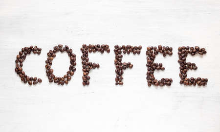 The inscription Coffee laid out of coffee beans. Isolated on white background.の写真素材