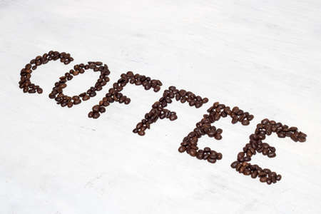 The inscription Coffee laid out of coffee beans. Isolated on white background.の写真素材