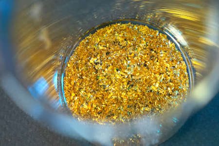 Pieces of gold in a cup. Encouraged RAM contacts.の写真素材