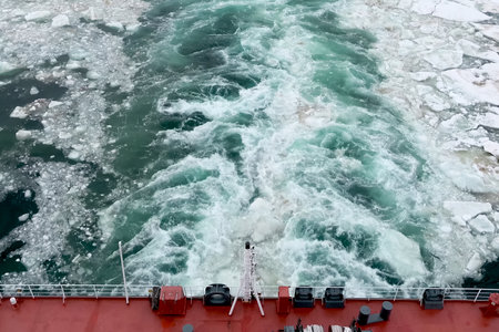 A trail on the water from the ship. Arctic and ice on the water. The propellers of the ship smeared the water.の写真素材