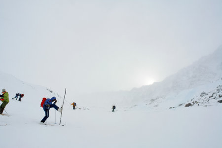 Skiers ride in the snow in the mountains of Baikalの写真素材