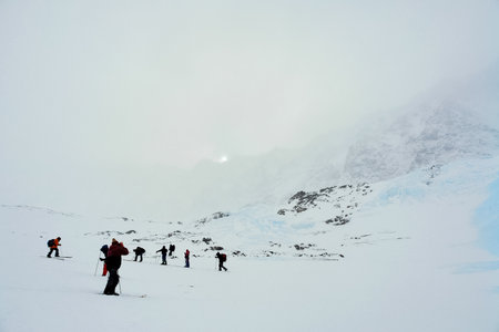 Skiers ride in the snow in the mountains of Baikalの写真素材