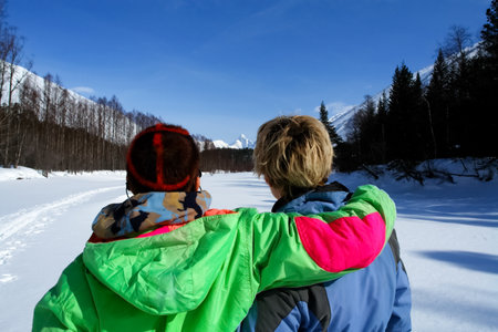 Two lesbians against the backdrop of the winter taiga landscape. Lesbian tourists in the woods.の写真素材