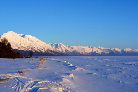 The winter landscape of Lake Baikal. Beautiful mountains in the snow and skyの写真素材