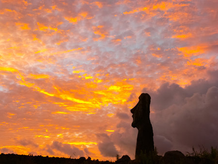 Statues of Easter Island in the background of the sunset. The melting of the Easter statue in the sunlight of the sunset.の写真素材