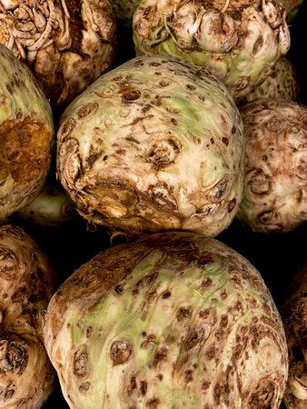 Many Celeriac for sale in a retail store.