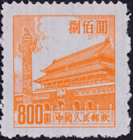 Orange illustration on white postage stamp features a building, column, and text. The design is printed on perforated paper.の写真素材