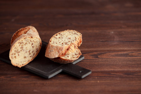 Freshly baked traditional bread on wooden table