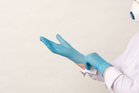 Hands of doctor putting on a medical gloves corona virus protection covid 19