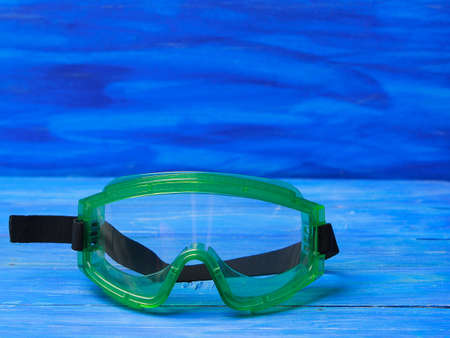 Plastic safety goggles on blue backgroundの写真素材