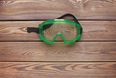 Plastic safety goggles on wooden backgroundの写真素材