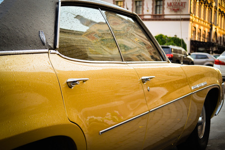 Odessa, Ukraine - July 15, 2015. Old yellow Buick after rainのeditorial素材