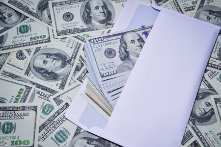 Dollars in an envelope on the background of dollarsの写真素材