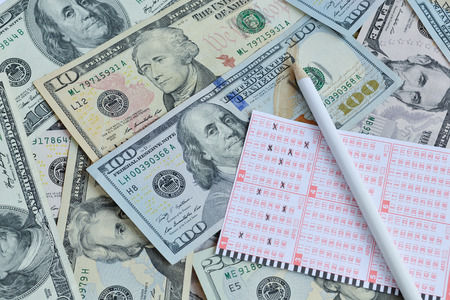 Win the lottery. Lottery ticket and pencil on dollar backgroundの写真素材