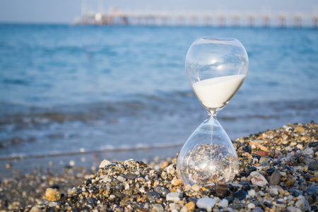 Hourglass on the beach, on the Mediterranean coast