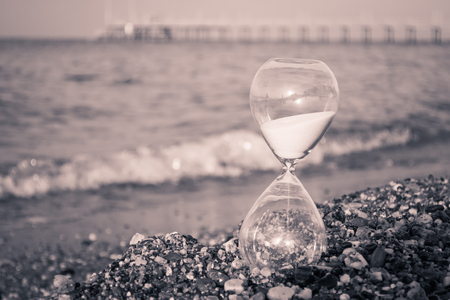 Hourglass on the beach, on the Mediterranean coastの写真素材