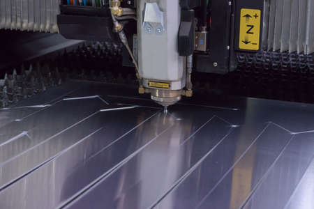 Laser cutting of flat sheet aluminum with sparks.の写真素材
