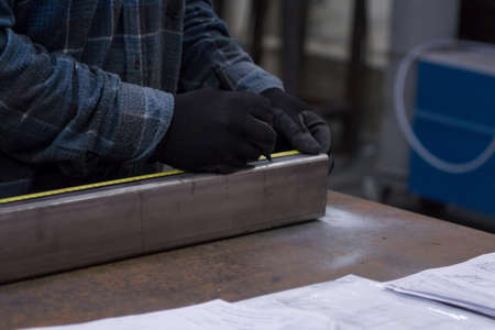 the man is measuring the metal profileの写真素材